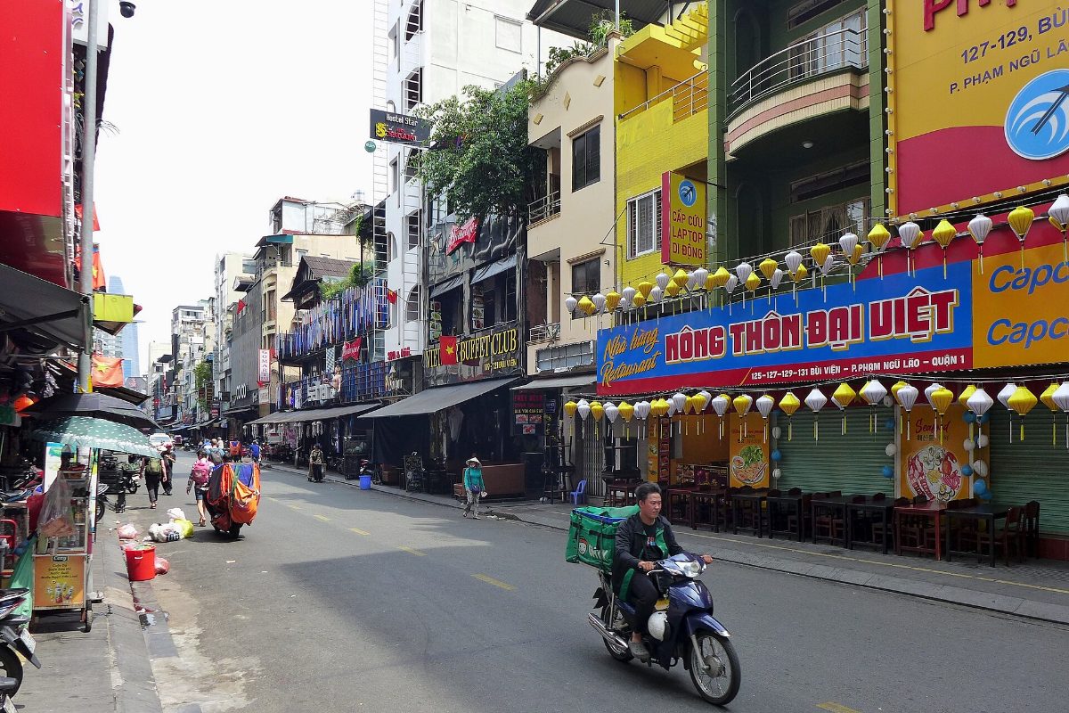 Bui Vien Street in Ho Chi Minh City by day, lined with shops and signs