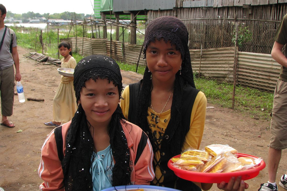 Muslim People in Vietnam 2026: Who Are Vietnamese Muslims? Cham Islam, Bani & Communities Cham girls selling waffles in a Cham village in the Mekong Delta