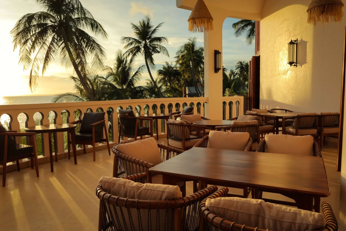Restaurant terrace under the palms at Le Viva Resort Mui Ne