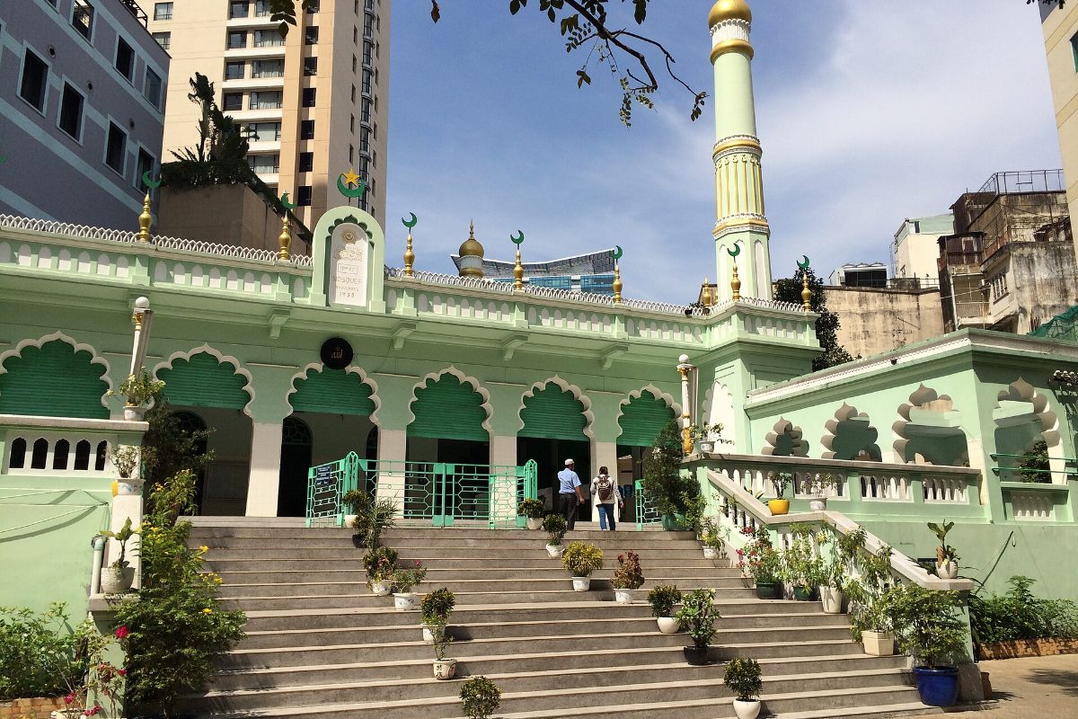 Green and white mosque with a minaret and front staircase in central Ho Chi Minh City