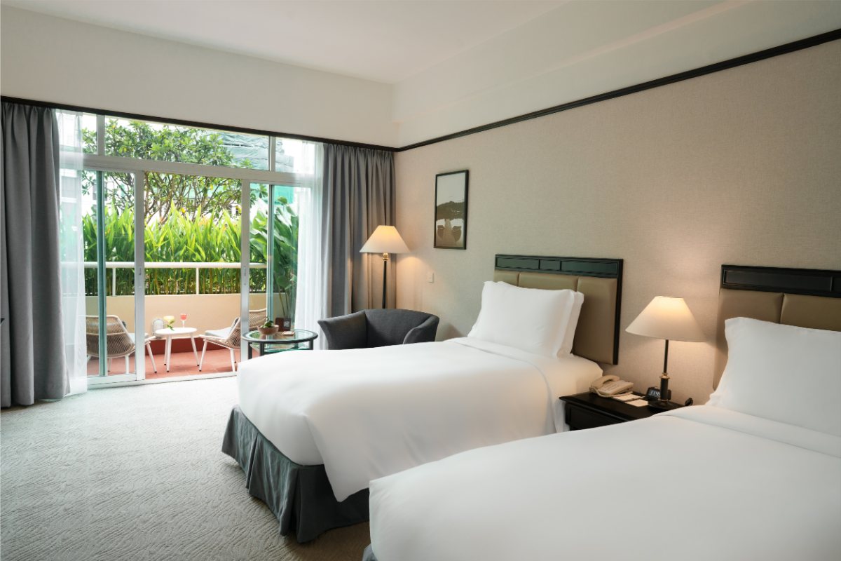 Deluxe room opening onto a private balcony at New World Saigon Hotel