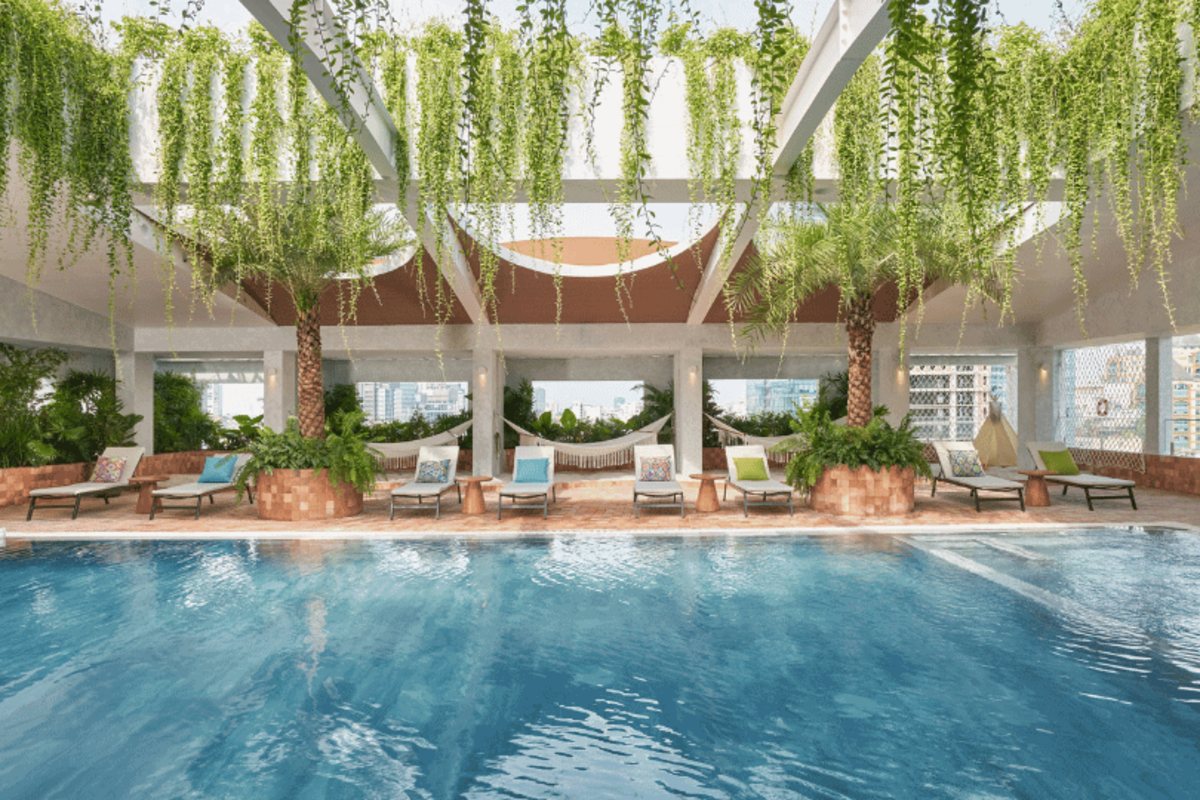 Silverland Mây Hotel Rooftop pool with hanging greenery at Silverland Mây Hotel