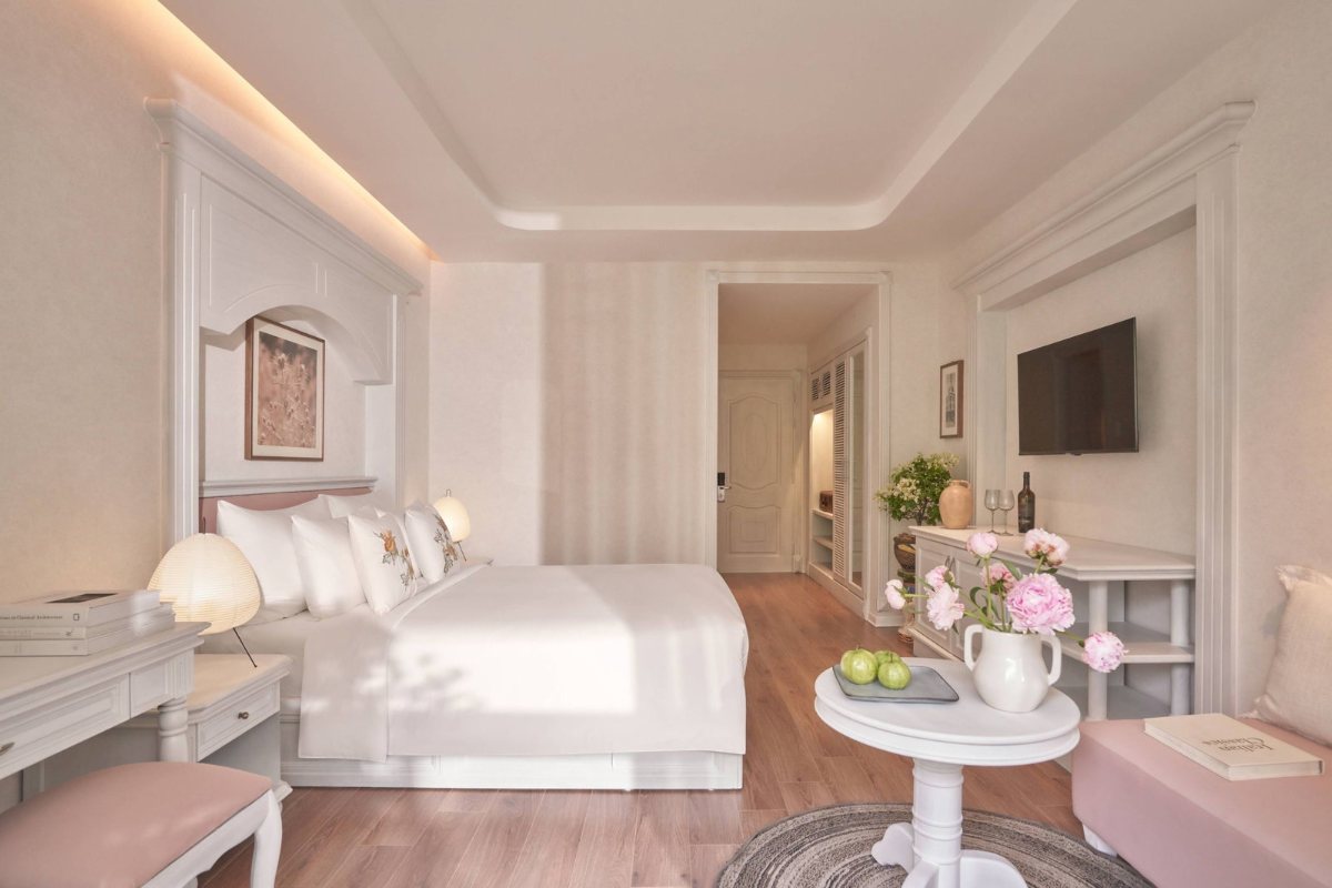 Bed in the Bougainvillaea Signature room at Silverland Mây Hotel