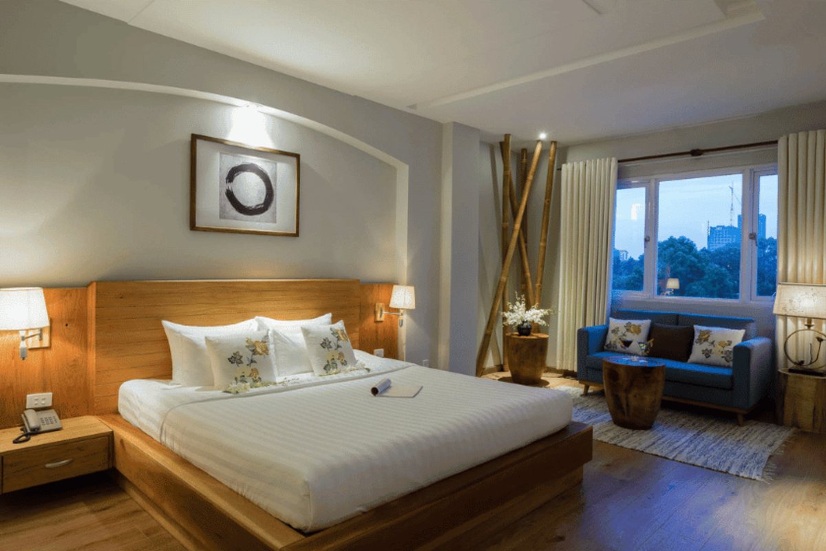 Suite with king bed and sofa at Silverland Yen Hotel