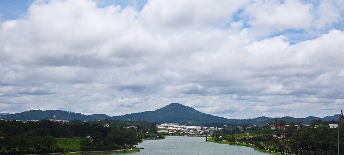 Xuan Huong Lake in central Da Lat with pine hills and Lang Biang mountain behind